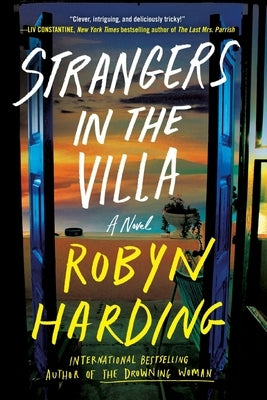 Paperback book "Strangers in the Villa" by Grand Central Publishing featuring an engaging cover design.