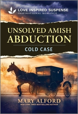 Mass market paperbound book "Unsolved Amish Abduction" by Love Inspired Suspense on a wooden table with soft lighting.